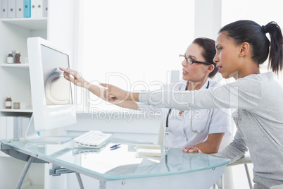 Doctor showing patient results on the computer
