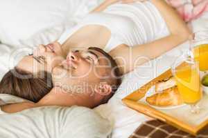 Cute couple having breakfast in bed