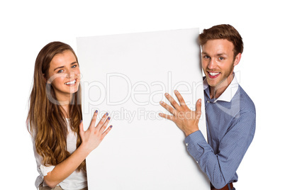 Happy young couple with blank board