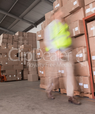 Blurred worker walking in warehouse