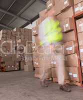 Blurred worker walking in warehouse