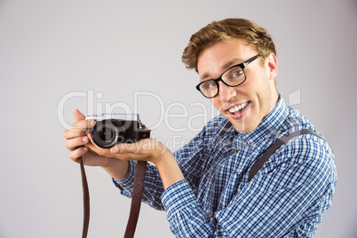 Geeky hipster holding a retro camera