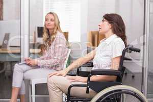 Businesswoman in wheelchair listening to presentation