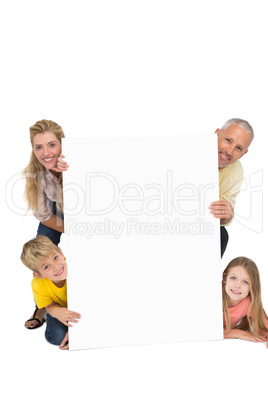 Happy family showing white card