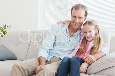 Casual father and daughter smiling at camera