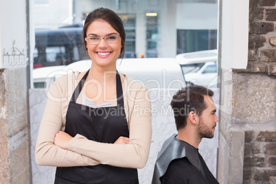 Pretty hair stylist smiling at camera