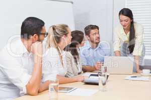 Business people listening a woman doing a presentation