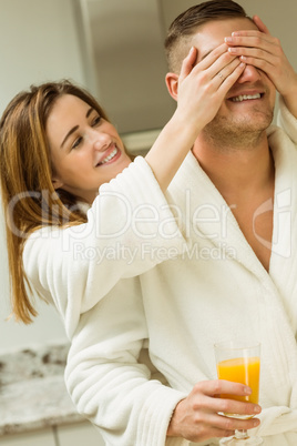 Couple drinking orange juice in bathrobes