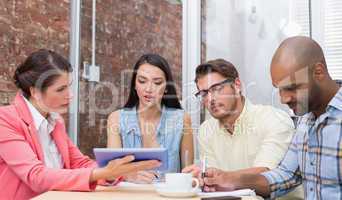 Smiling business people working on tablet pc