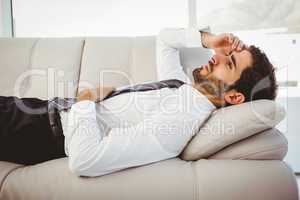Sick businessman lying on the couch