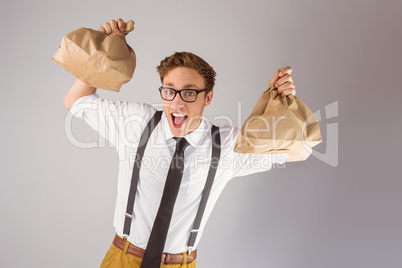 Geeky businessman holding paper bags