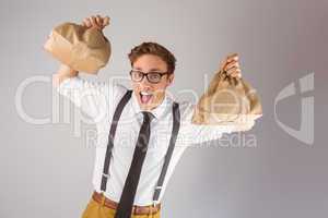 Geeky businessman holding paper bags