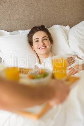 Cute couple having breakfast in bed