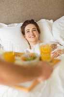 Cute couple having breakfast in bed