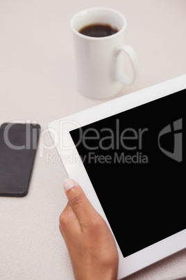 Casual businesswoman using tablet pc