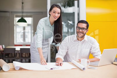 Casual architecture team working together at desk