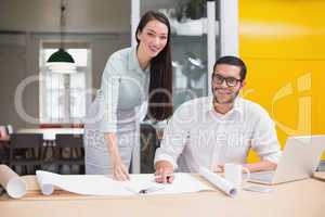 Casual architecture team working together at desk