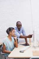 Man showing something to his colleague on the laptop