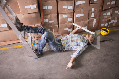 Worker lying on the floor in warehouse