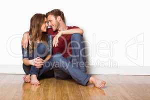 Young couple sitting on floor