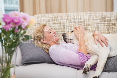 Beautiful blonde on couch with pet dog