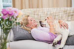 Beautiful blonde on couch with pet dog