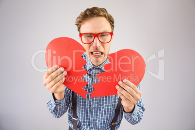 Geeky hipster holding a broken heart