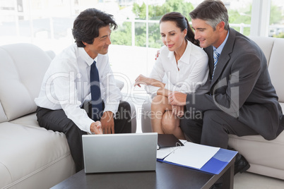 Business team looking at a laptop