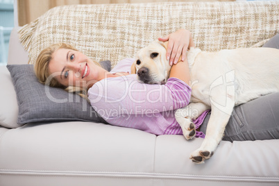 Beautiful blonde on couch with pet dog