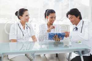 Smiling doctors using a tablet pc