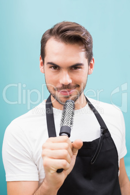 Handsome hair stylist smiling at camera