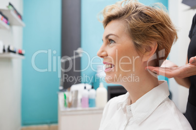 Hairdresser styling customers hair