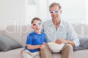 Casual father and son watching a 3d movie