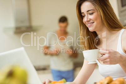 Woman using her laptop at breakfast