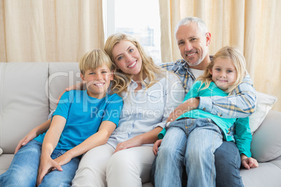 Happy family smiling at camera