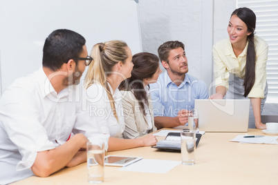 Business people listening a woman doing a presentation