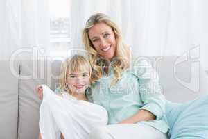 Mother sitting on the couch with her daughter