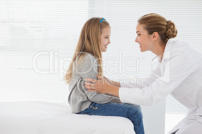 Happy doctor making patient smile