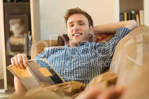 Young man reading on his couch