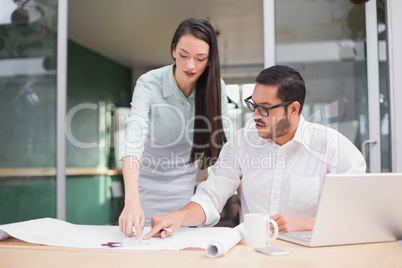 Casual architecture team working together at desk