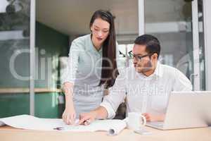 Casual architecture team working together at desk