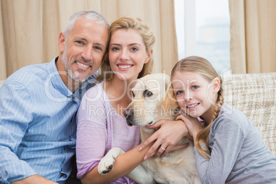 Parents and daughter with pet labrador