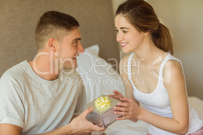 Man giving his pretty girlfriend a gift