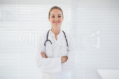 Cheerful doctor with arms folded