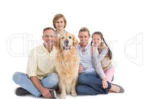 Portrait of smiling family sitting together with their dog