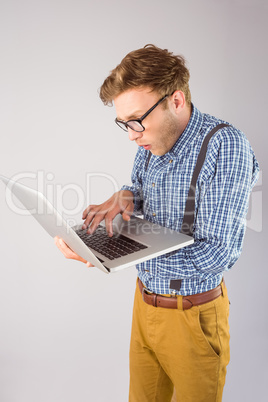 Geeky businessman using his laptop