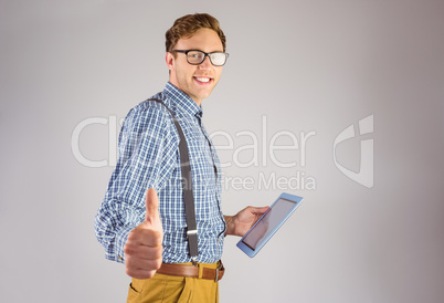 Geeky businessman using his tablet pc