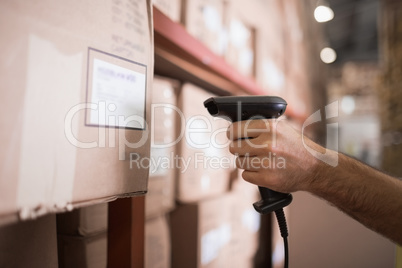 Close up of worker holding scanner in warehouse