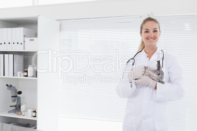 Vet holding a small rabbit