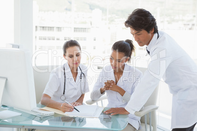Doctors reviewing notes together